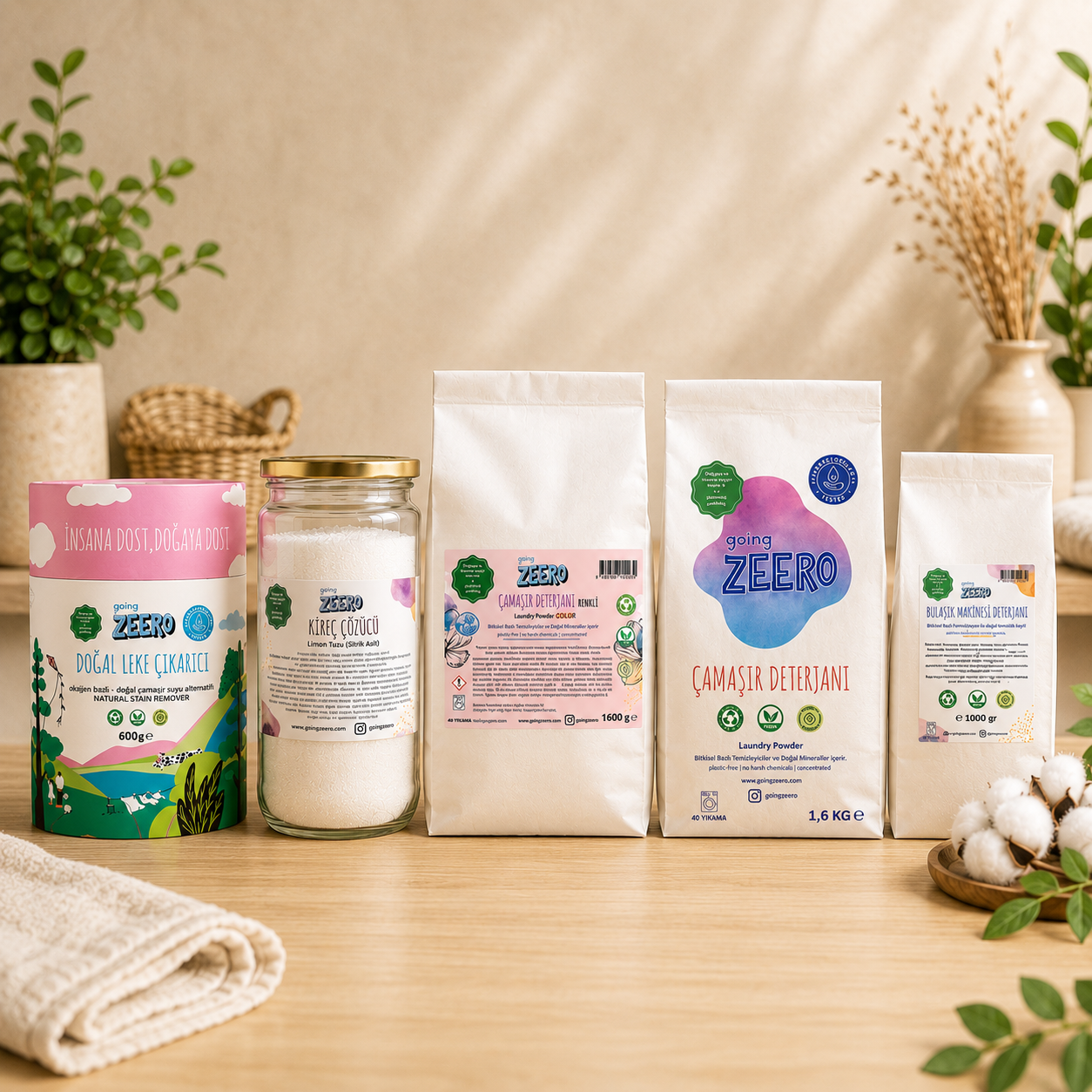 Zeero natural cleaning gift set with laundry detergent, dishwasher detergent, stain remover and descaler on wooden kitchen counter